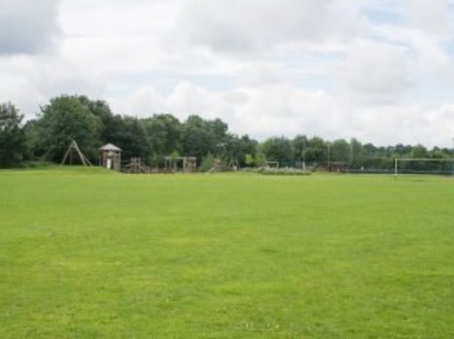 Photo of the Jubilee Playing Fields in Bunbury, with a large grassy field and a children's adventure play area in the background